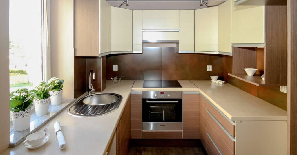 A decluttered, sleek, older minimalist kitchen with no clutter.