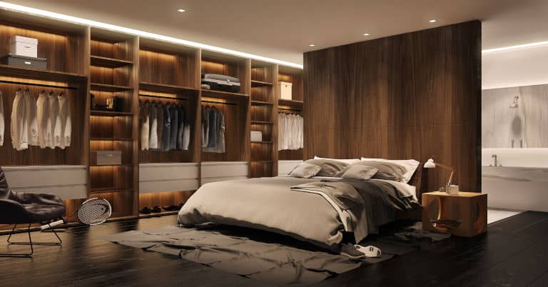 A bedroom and closet with some clutter.