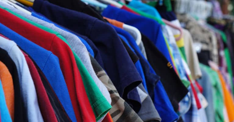 Used clothes on a rack on the street.