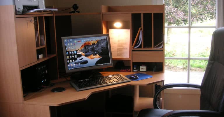 A decluttered corner desk in a home office.