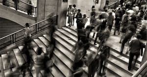 Busy, high stress people on stairs.