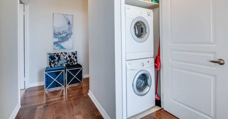 Decluttered laundry room with washer dryer closet.