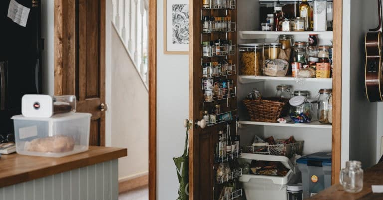A kitchen pantry with clutter.